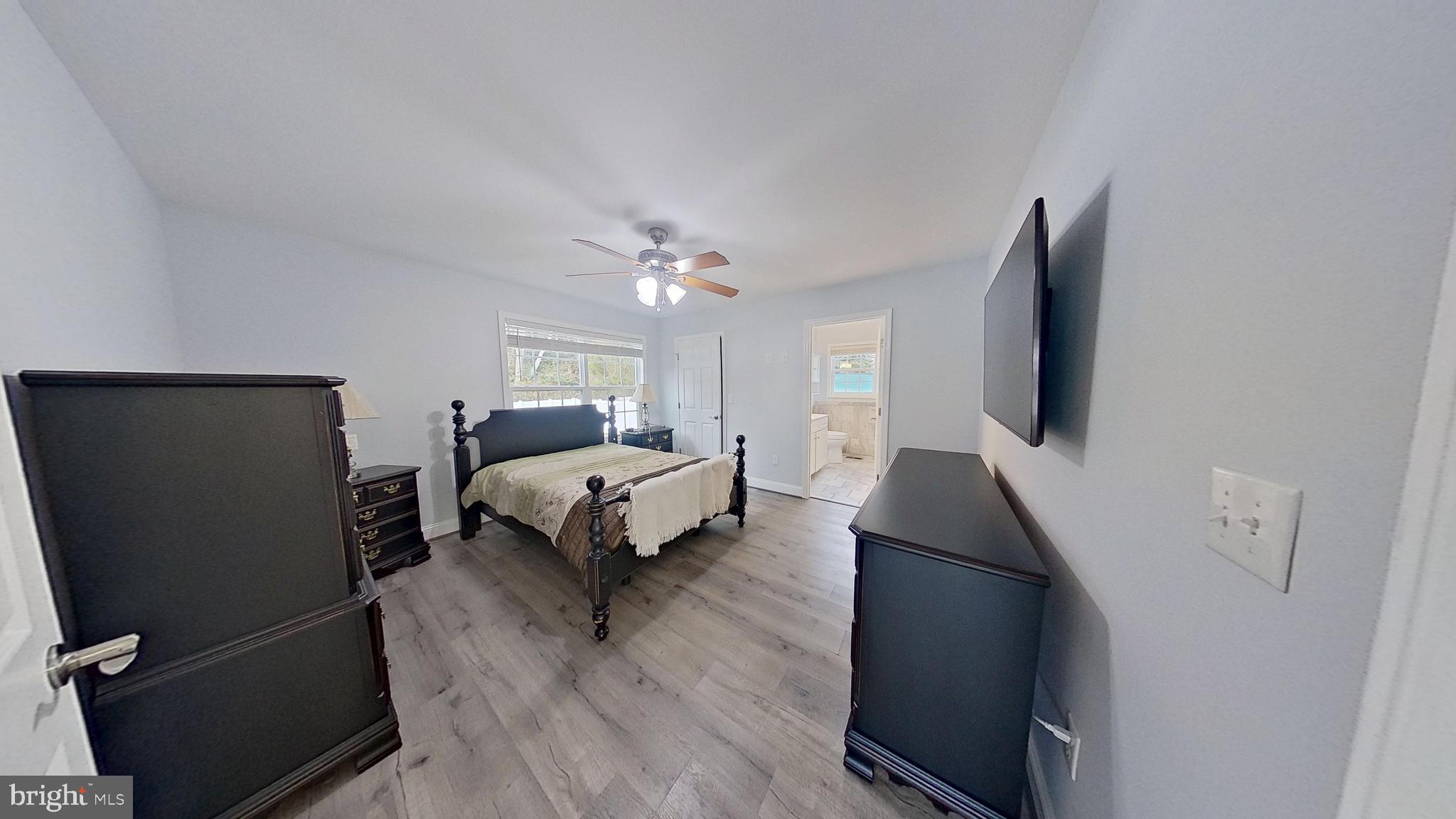 95 Rolando Drive Colonial Beach, VA 22443 - Photo 24 of 39 a bedroom with a bed and a flat tv screen on a dresser