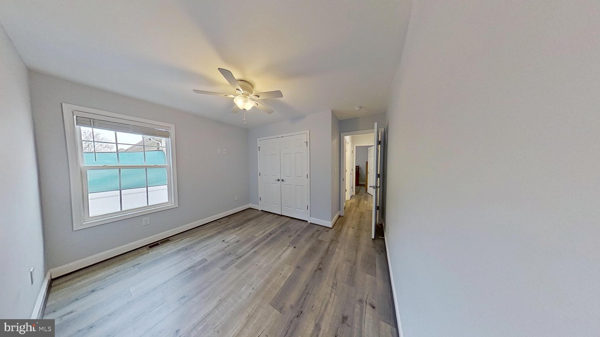 95 Rolando Drive Colonial Beach, VA 22443 - Photo 26 of 39 an empty room with wooden floor and windows