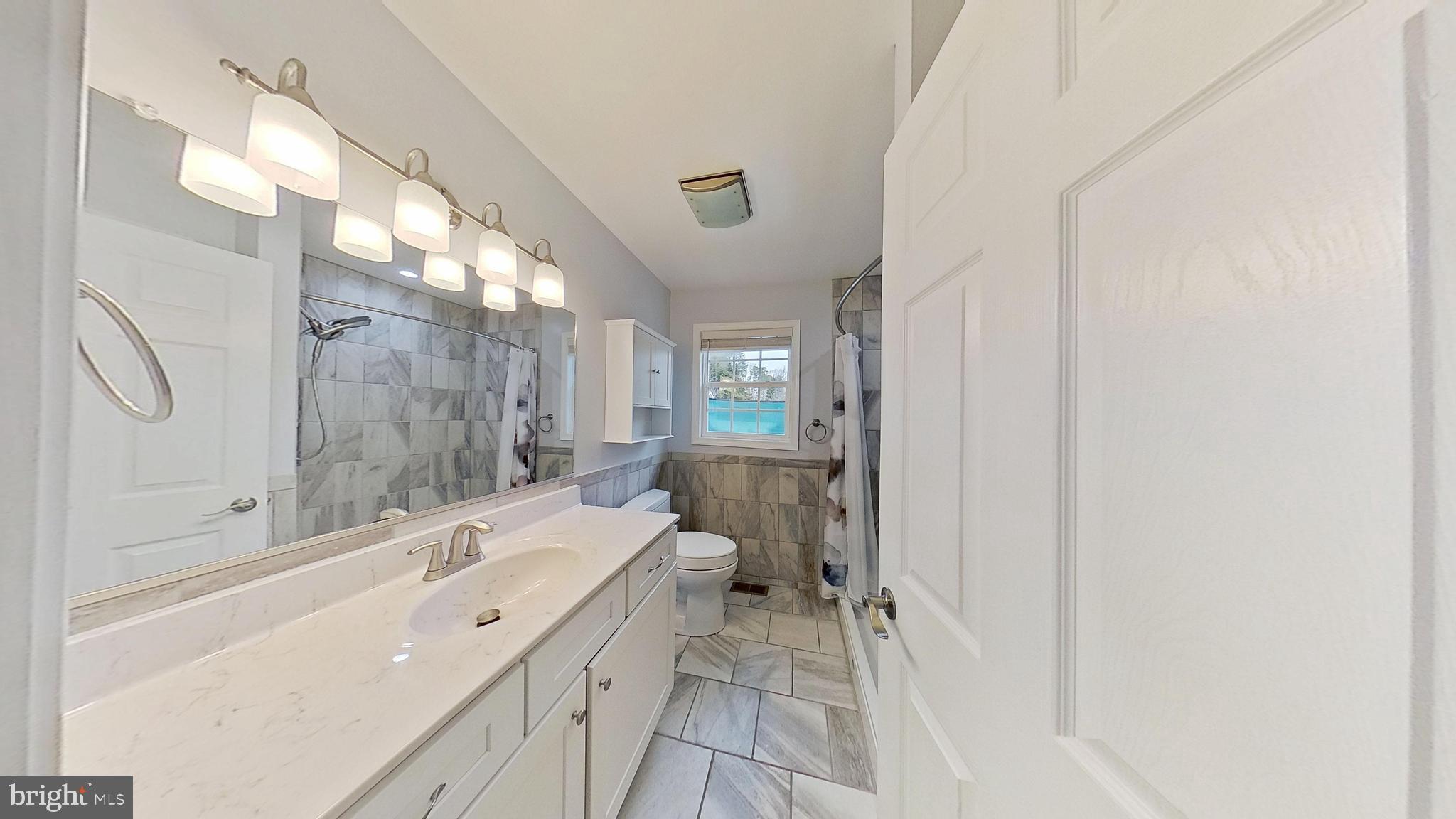 95 Rolando Drive Colonial Beach, VA 22443 - Photo 30 of 39 a spacious bathroom with a sink mirror toilet and a bathtub