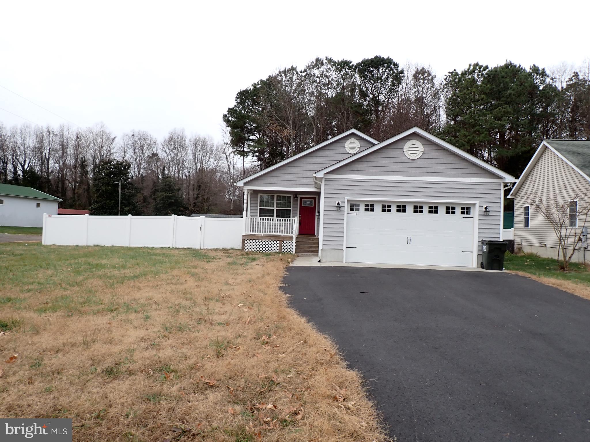 95 Rolando Drive Colonial Beach, VA 22443 - Photo 3 of 39 a front view of a house with a yard and garage