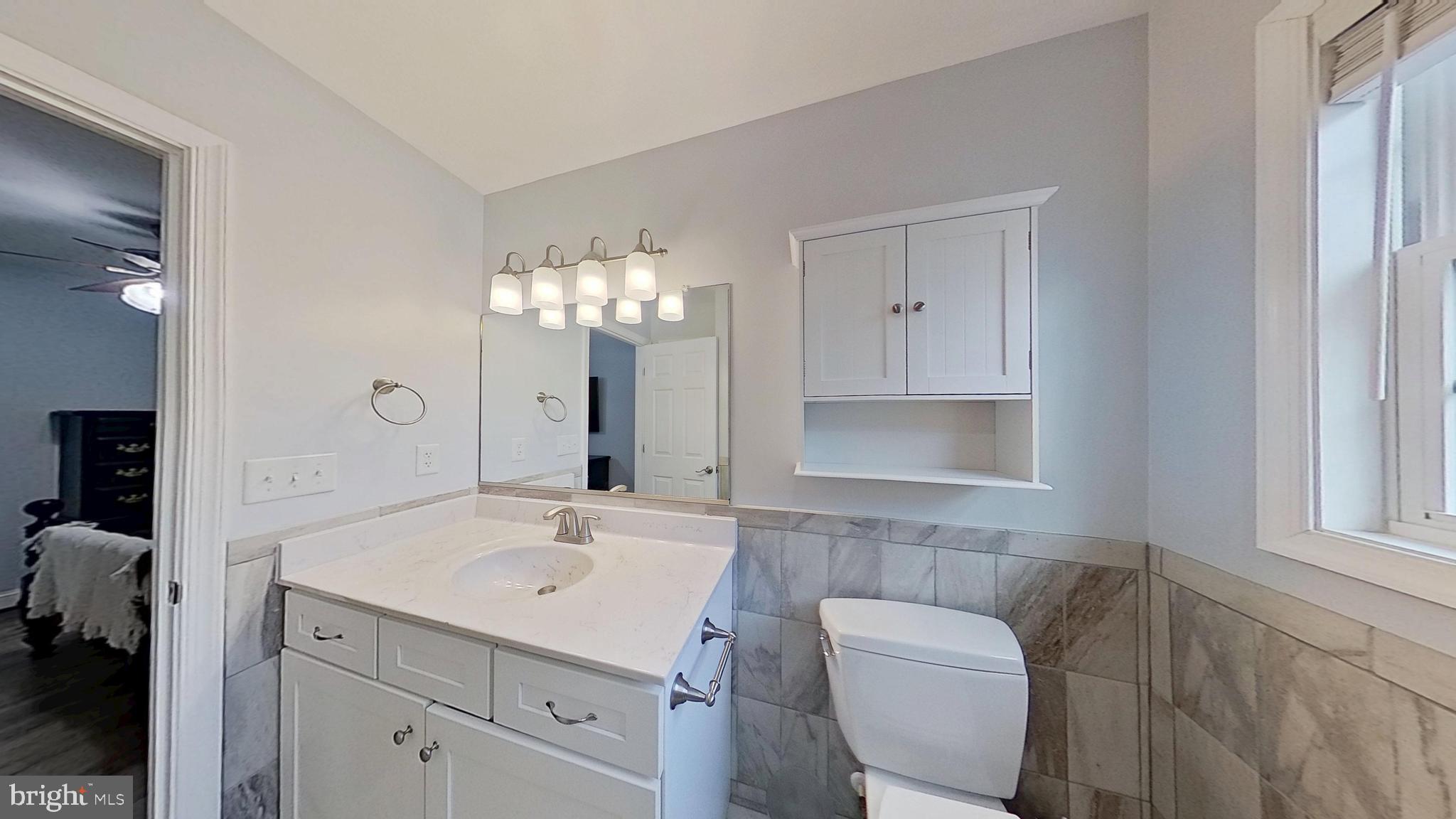 95 Rolando Drive Colonial Beach, VA 22443 - Photo 32 of 39 a bathroom with a sink a toilet and a mirror