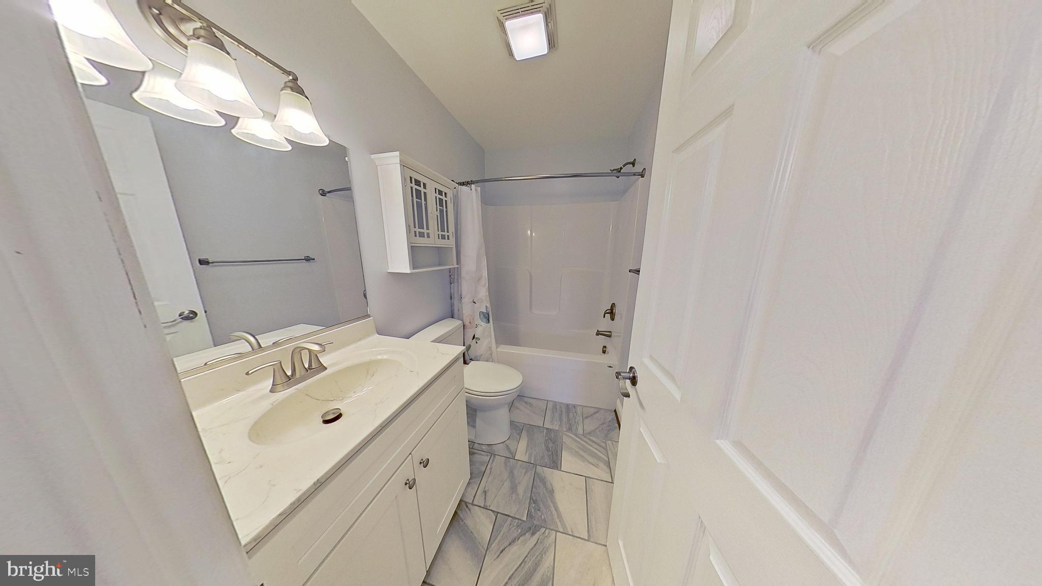 95 Rolando Drive Colonial Beach, VA 22443 - Photo 33 of 39 a bathroom with a sink a toilet and shower