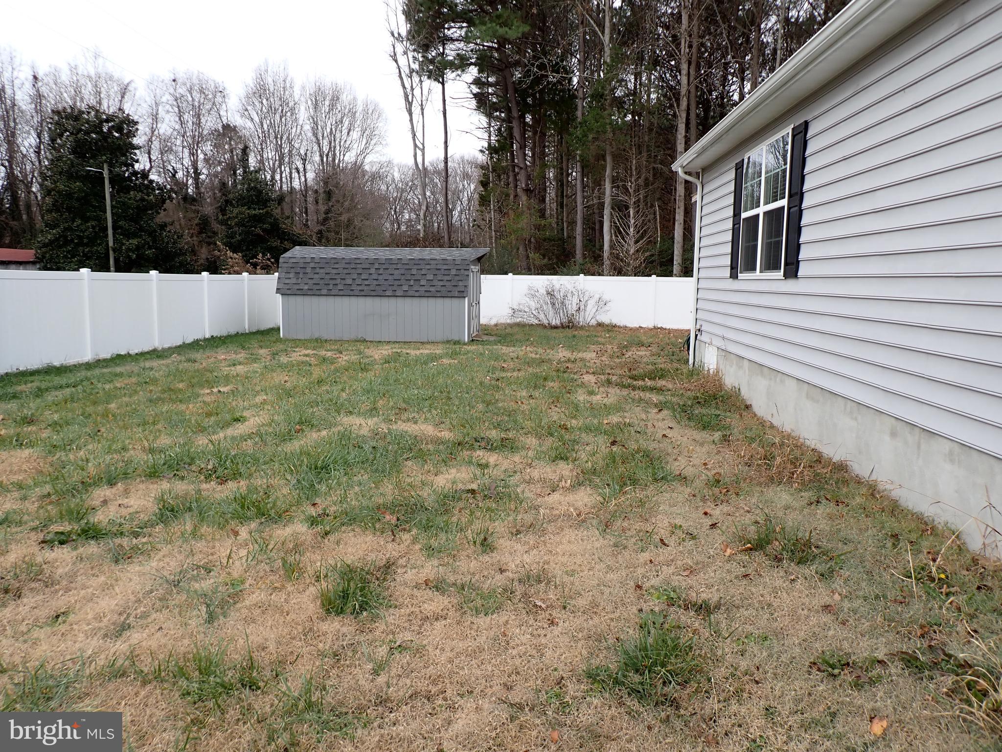 95 Rolando Drive Colonial Beach, VA 22443 - Photo 5 of 39 a backyard of a house with lots of green space
