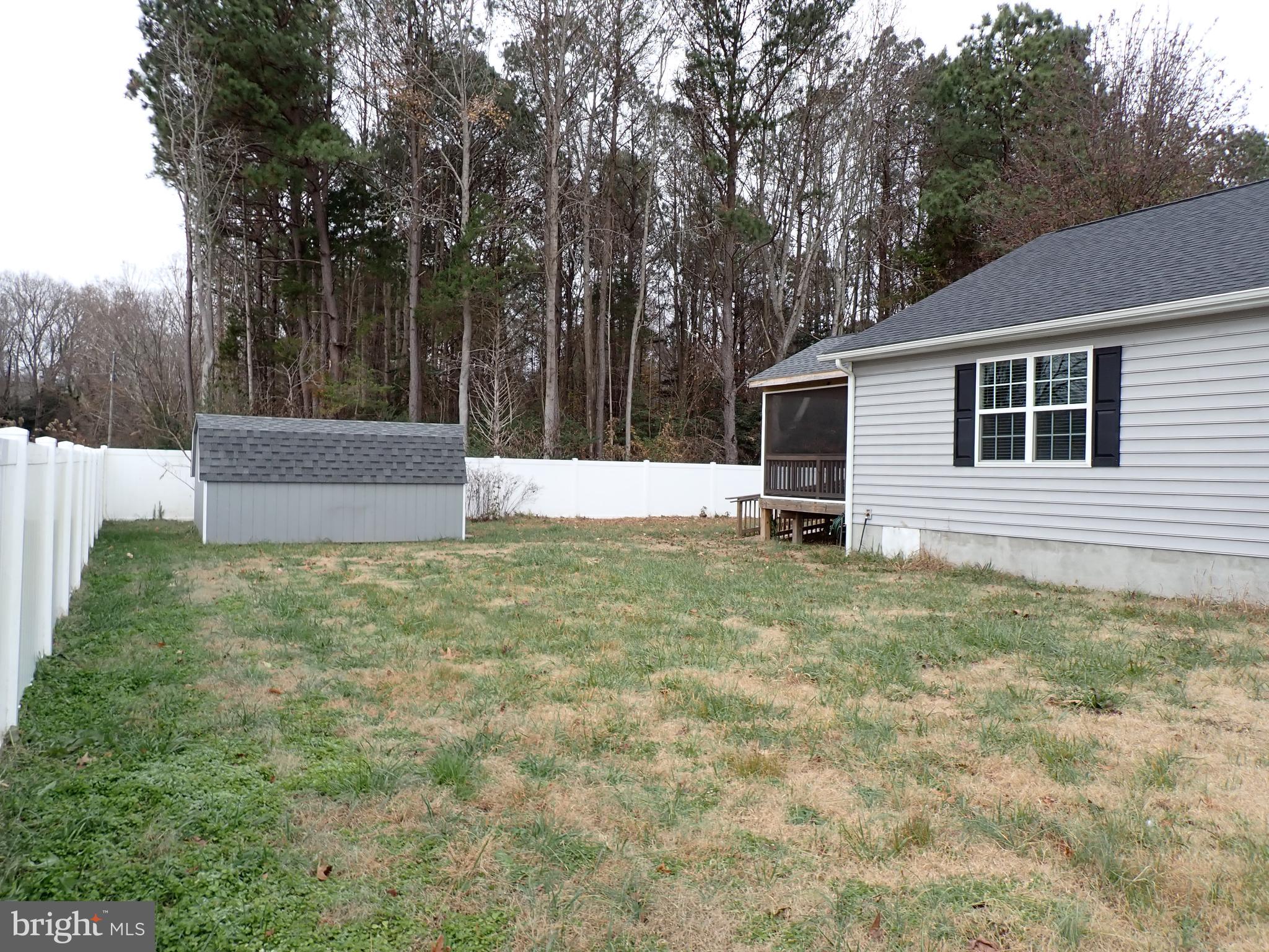95 Rolando Drive Colonial Beach, VA 22443 - Photo 6 of 39 a backyard of a house with lots of green space