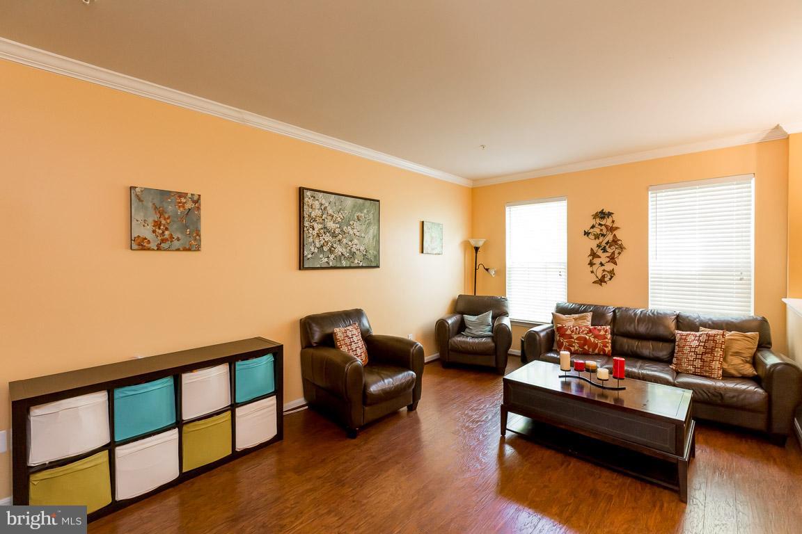 8042 Wright Place, Unit 103 Jessup, MD 20794 - Photo 2 of 22 a living room with furniture window and a wooden floor