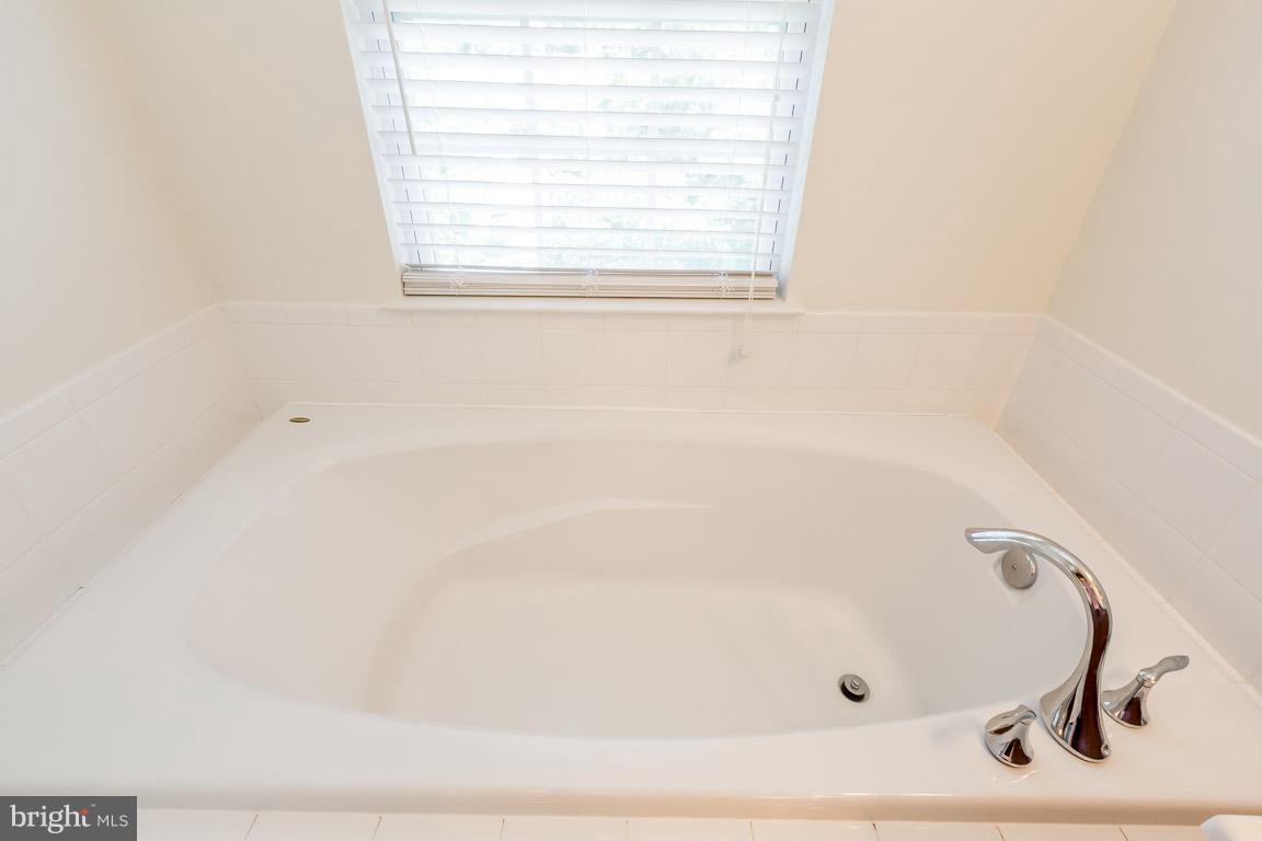 8042 Wright Place, Unit 103 Jessup, MD 20794 - Photo 15 of 22 a bathroom with a bathtub