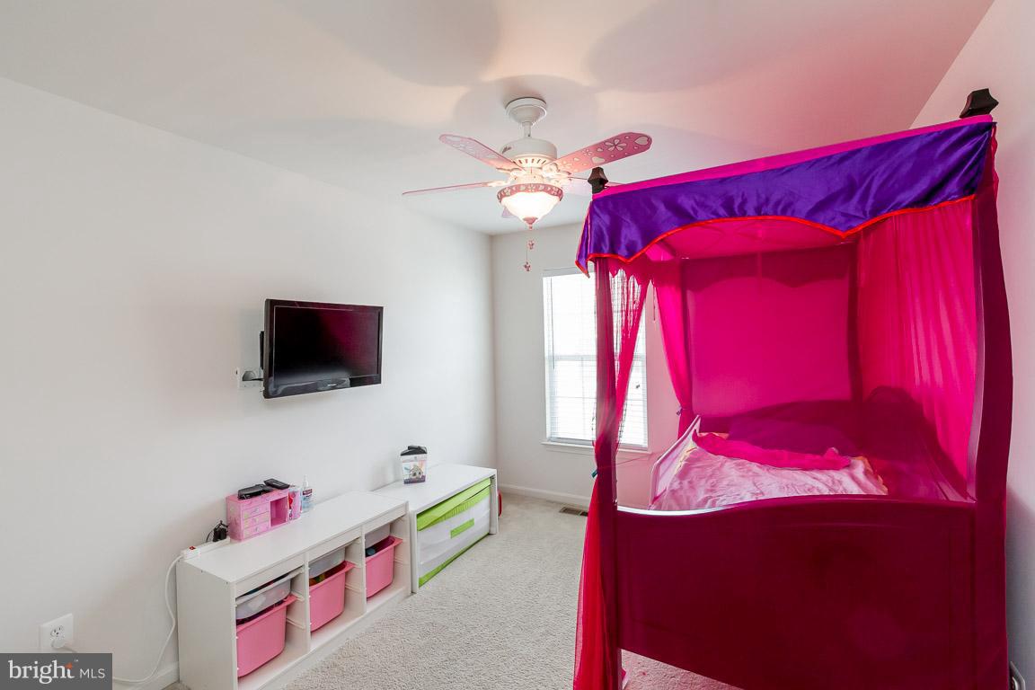 8042 Wright Place, Unit 103 Jessup, MD 20794 - Photo 16 of 22 a living room with furniture and a flat screen tv