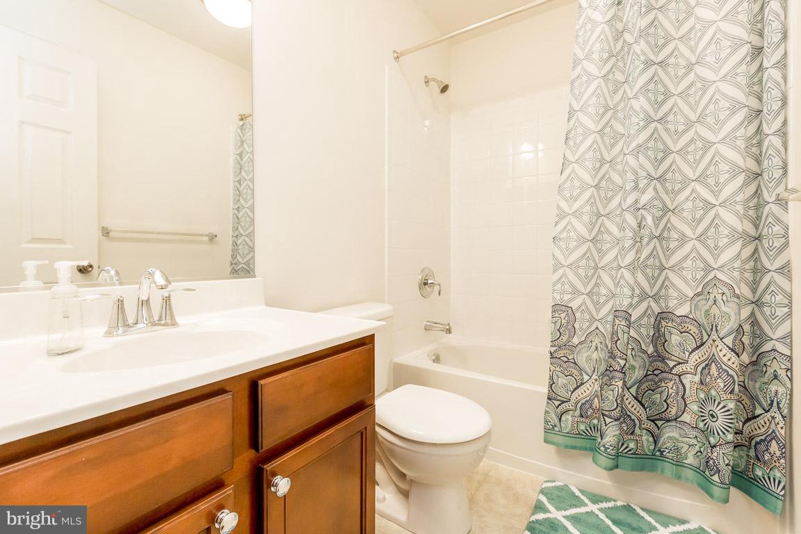 8042 Wright Place, Unit 103 Jessup, MD 20794 - Photo 17 of 22 a bathroom with a sink a toilet and shower