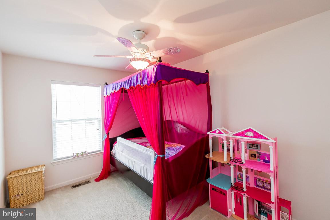 8042 Wright Place, Unit 103 Jessup, MD 20794 - Photo 18 of 22 a bedroom with a bed and a window