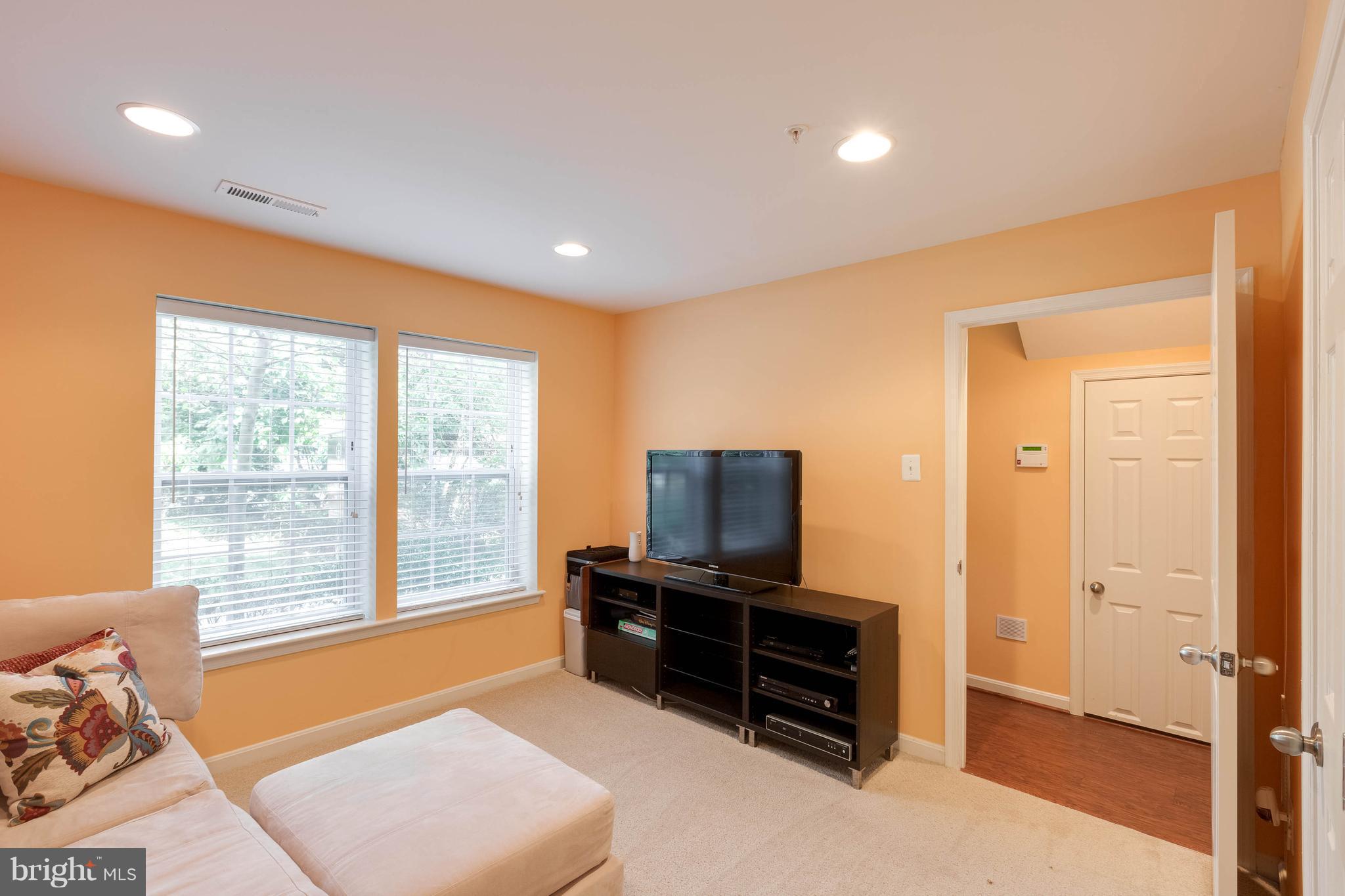 8042 Wright Place, Unit 103 Jessup, MD 20794 - Photo 20 of 22 a living room with furniture and a flat screen tv
