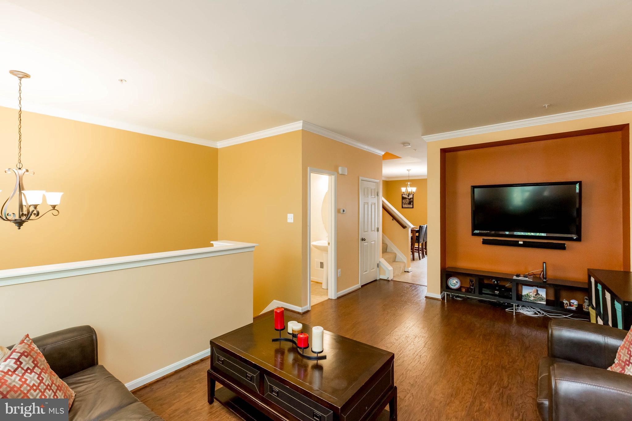 8042 Wright Place, Unit 103 Jessup, MD 20794 - Photo 4 of 22 a living room with furniture and a flat screen tv