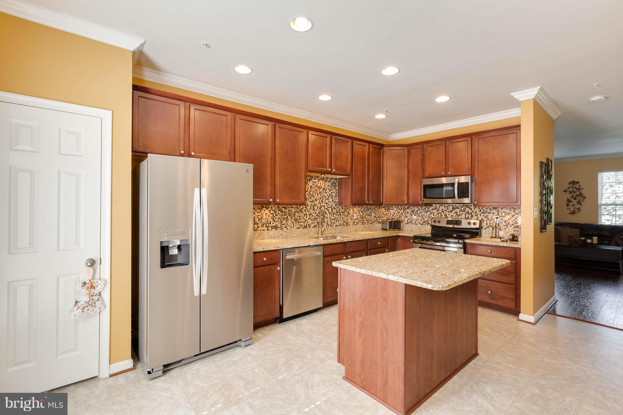 8042 Wright Place, Unit 103 Jessup, MD 20794 - Photo 6 of 22 a kitchen with stainless steel appliances granite countertop a refrigerator stove sink and dishwasher