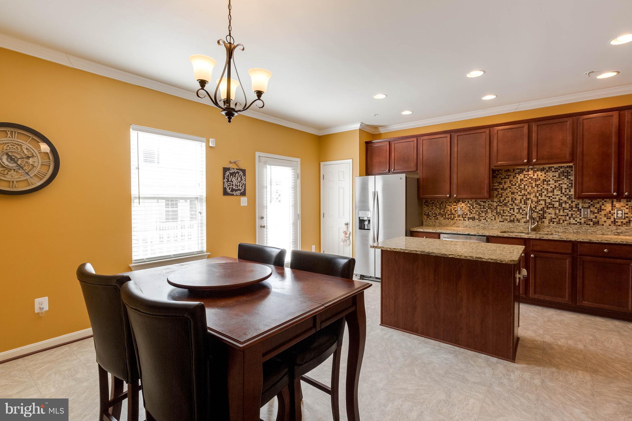 8042 Wright Place, Unit 103 Jessup, MD 20794 - Photo 10 of 22 a kitchen with a table and chairs in it