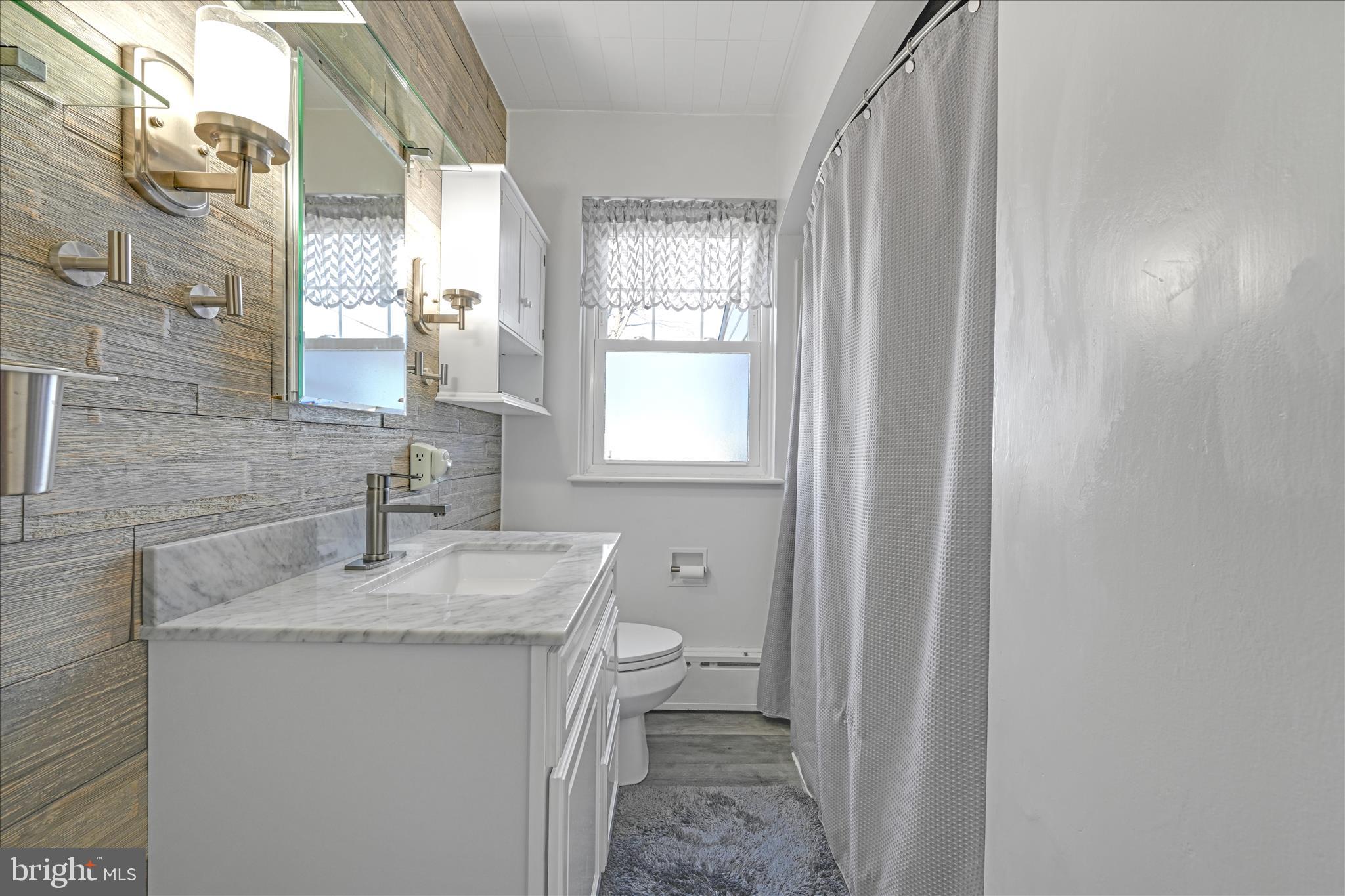 401 Park Road Fleetwood, PA 19522 - Photo 29 of 47 a bathroom with a sink toilet and window