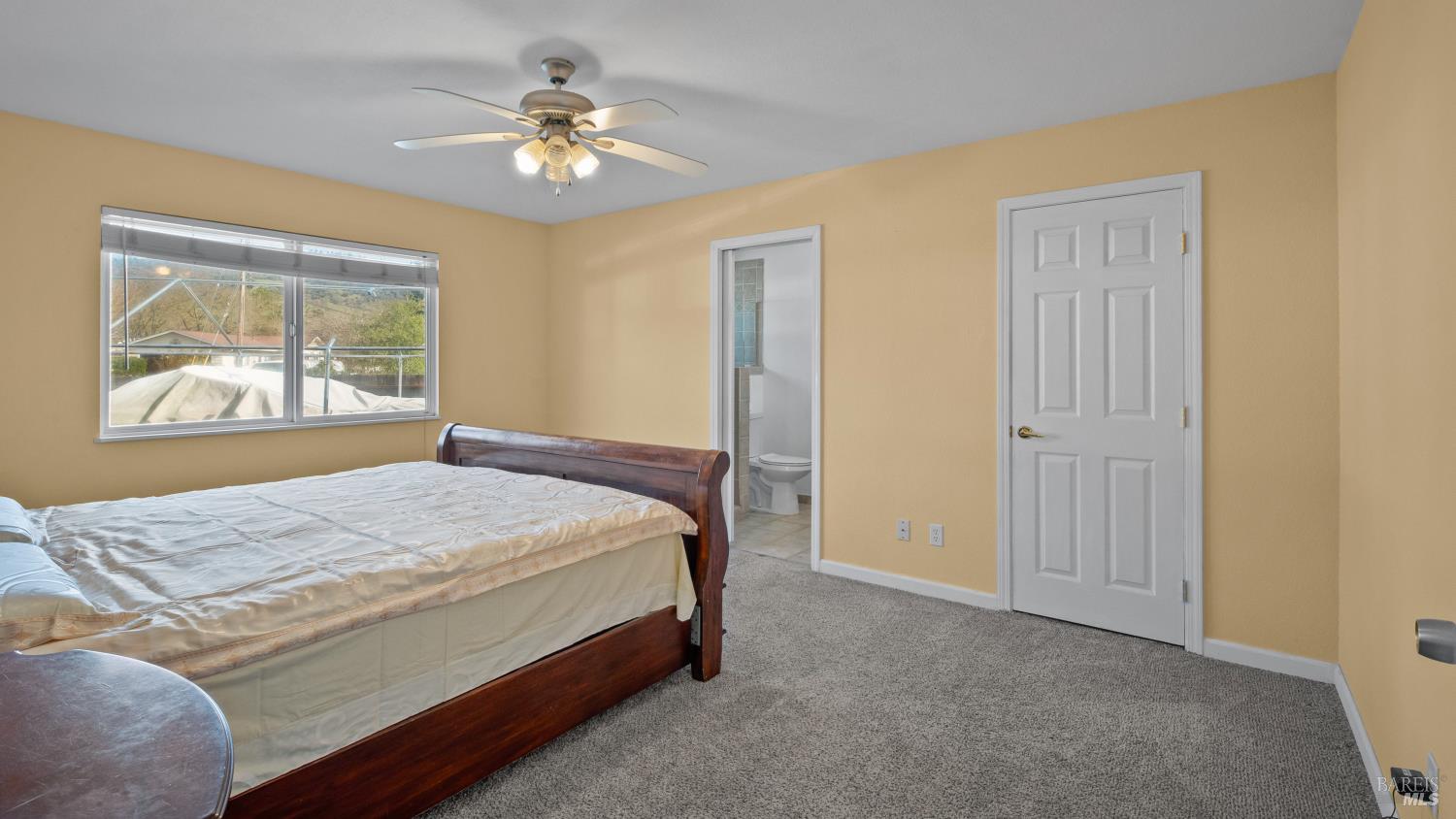 5036 Algiers Avenue Santa Rosa, CA 95409 - Photo 15 of 34 a bedroom with a bed and a chandelier