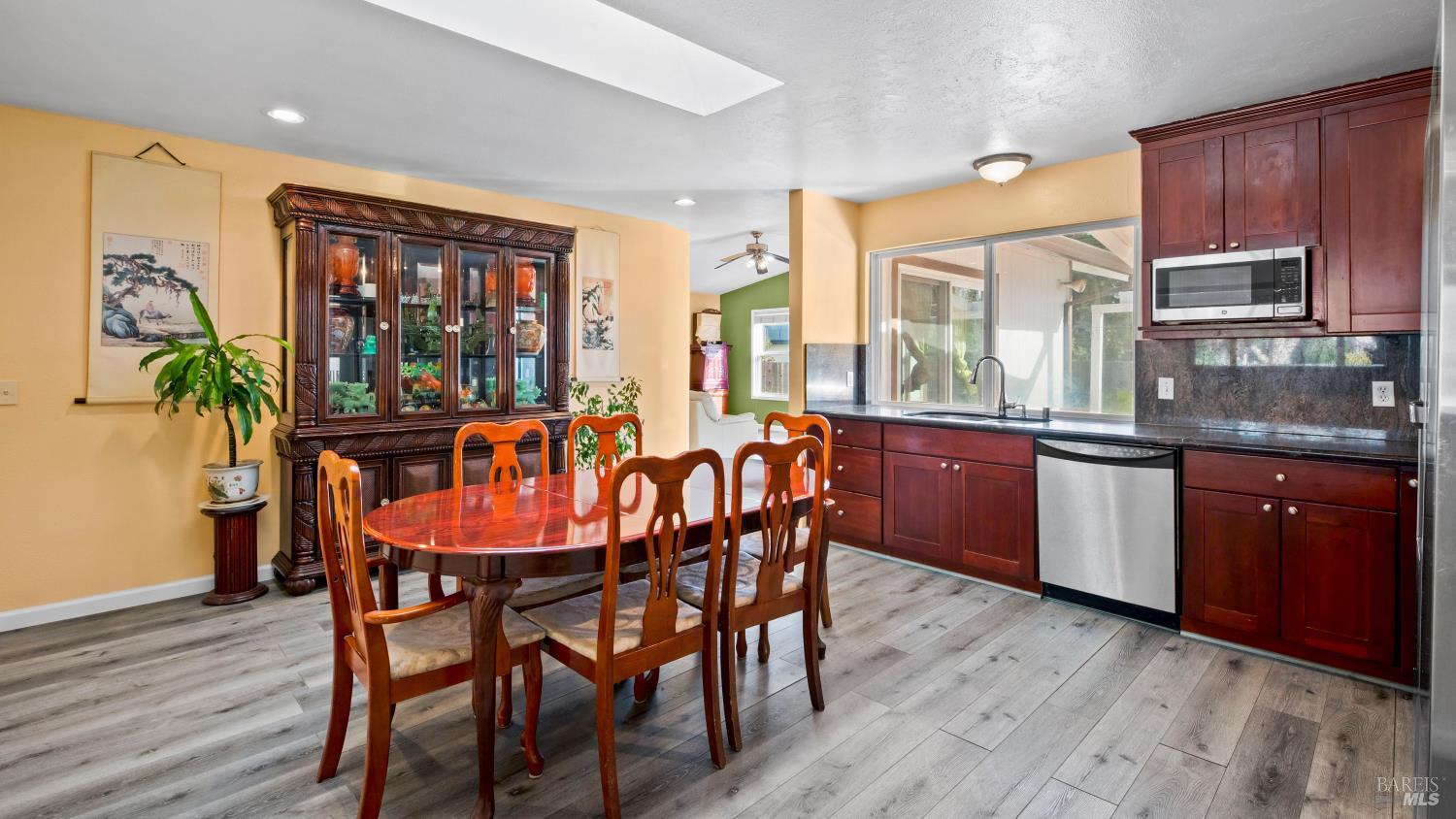 5036 Algiers Avenue Santa Rosa, CA 95409 - Photo 9 of 34 a dining room with furniture a large window and wooden floor