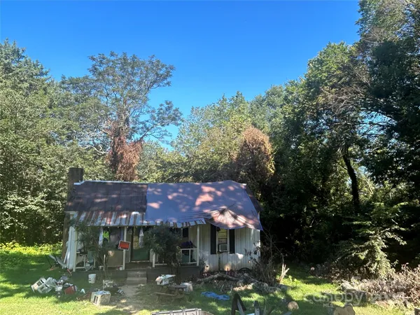 a front view of house with yard and trees
