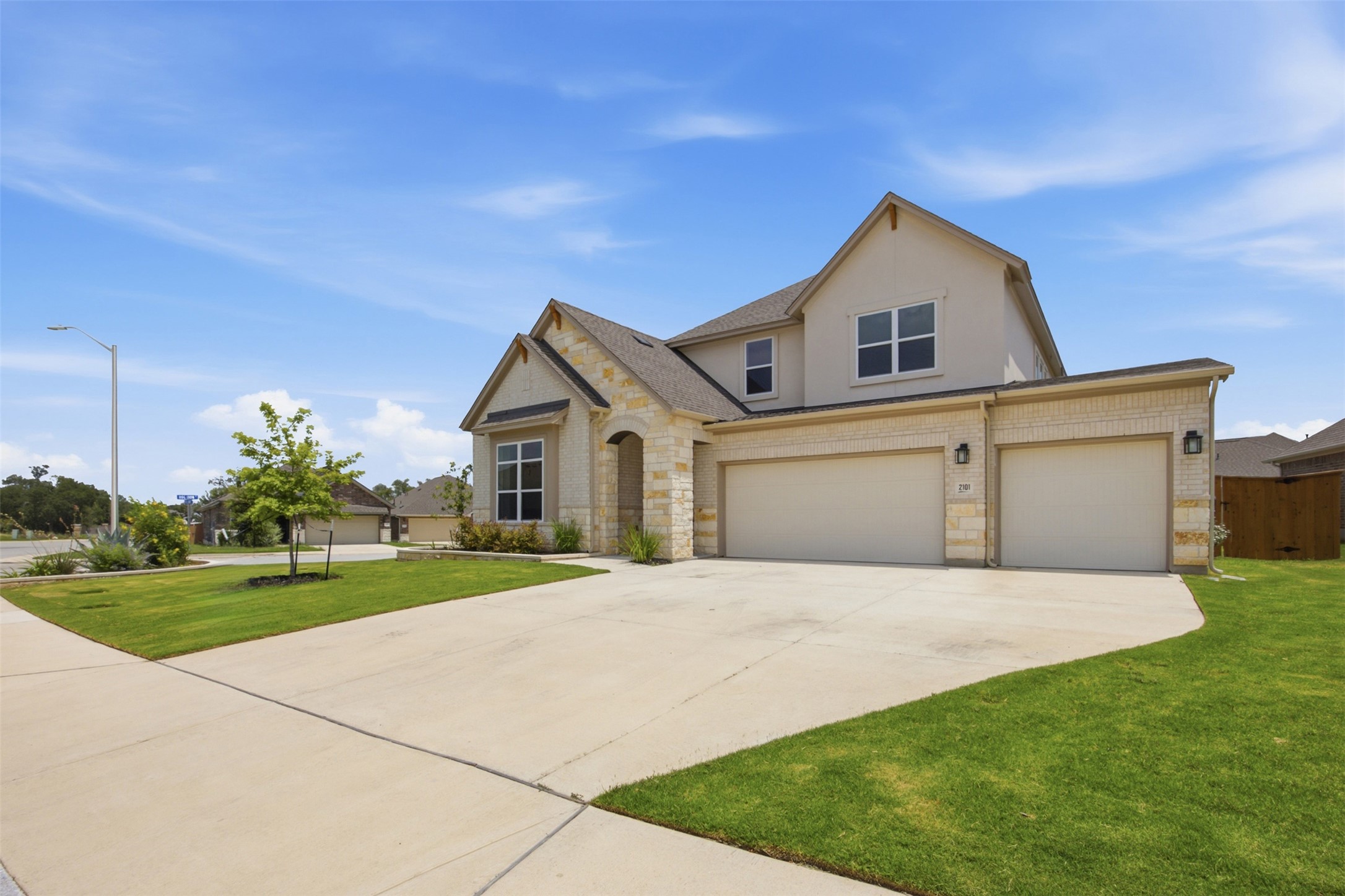 2101 Little Snake Way Georgetown, TX 78633 - Photo 4 of 37 Modern stone and stucco exterior with an inviting arched entry and spacious concrete driveway.