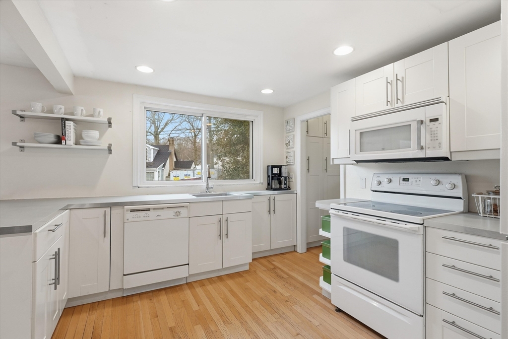 9 Pinewood Avenue Beverly, MA 01915 - Photo 12 of 41 a kitchen with granite countertop white cabinets and white appliances