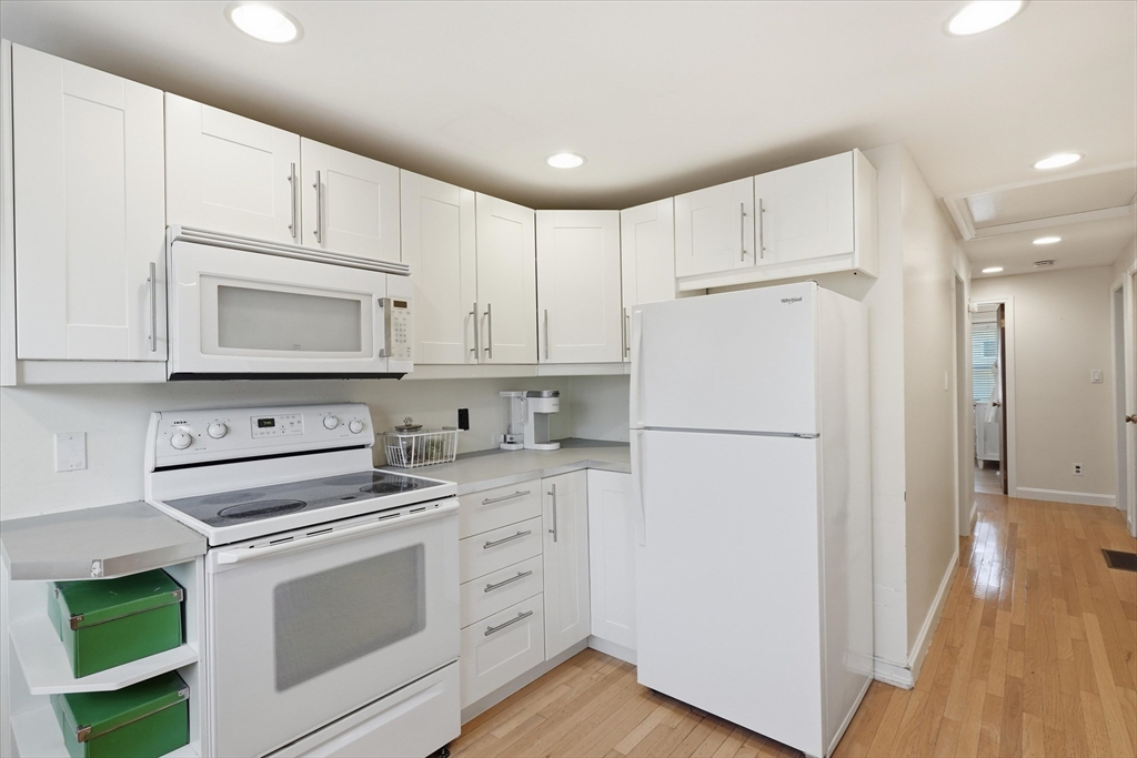 9 Pinewood Avenue Beverly, MA 01915 - Photo 14 of 41 a white refrigerator freezer sitting inside of a kitchen