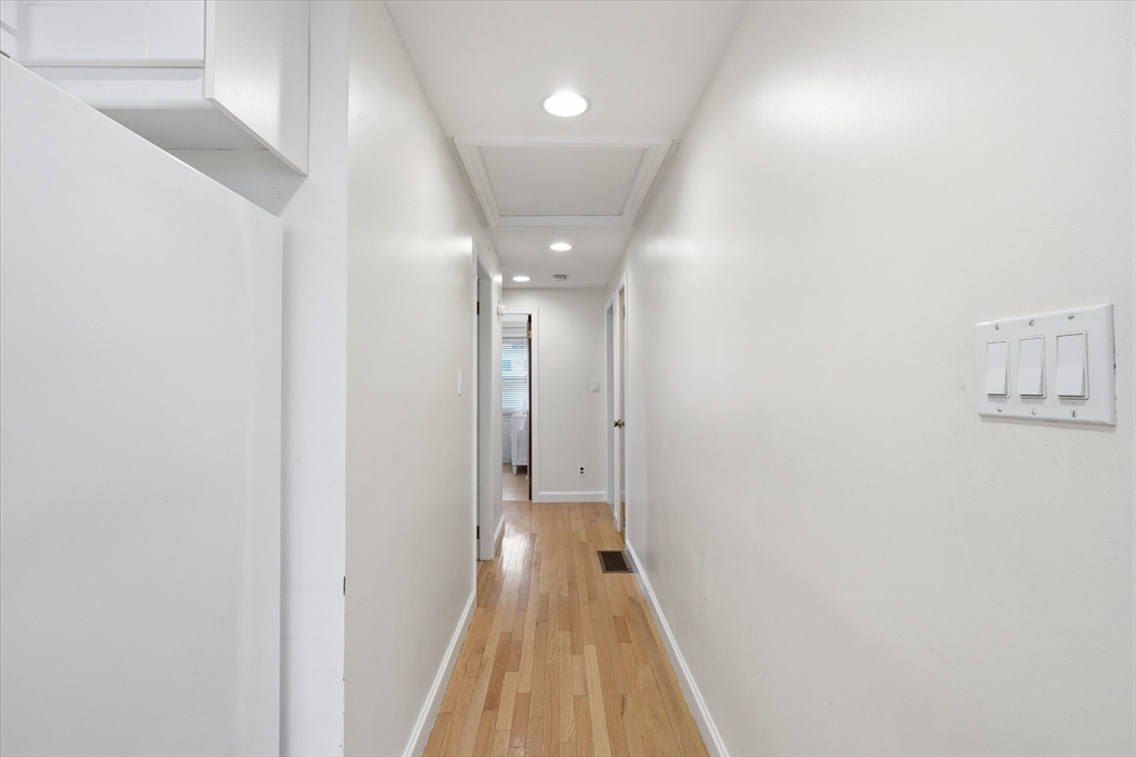 9 Pinewood Avenue Beverly, MA 01915 - Photo 15 of 41 a view of a hallway with wooden floor