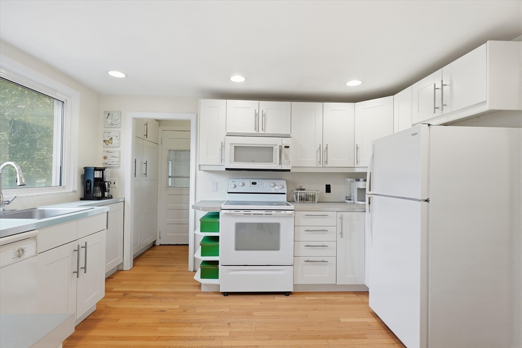 9 Pinewood Avenue Beverly, MA 01915 - Photo 25 of 41 a kitchen with white cabinets and white stainless steel appliances