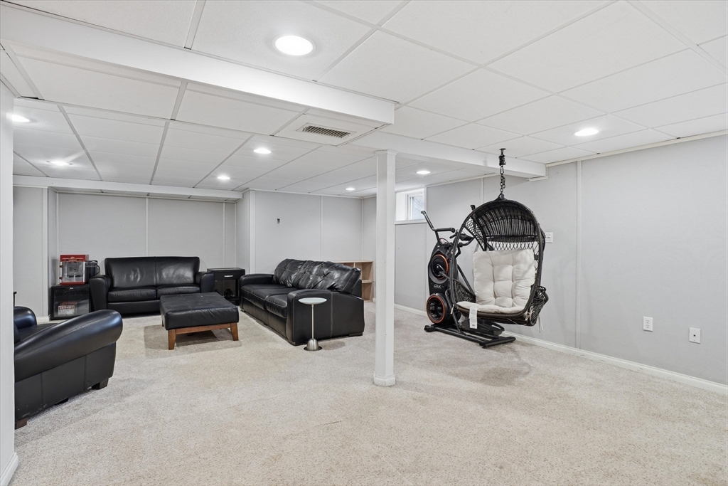 9 Pinewood Avenue Beverly, MA 01915 - Photo 29 of 41 a living room with furniture gym equipment and a ceiling fan