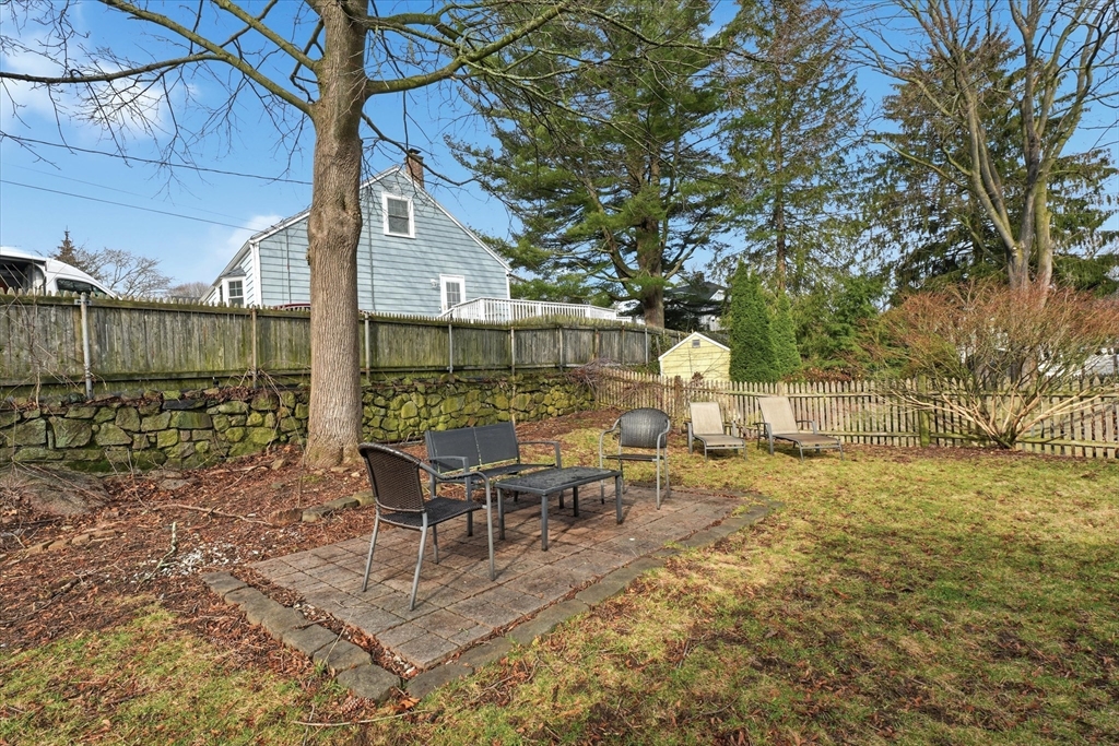 9 Pinewood Avenue Beverly, MA 01915 - Photo 34 of 41 a view of a patio with table and chairs under an umbrella