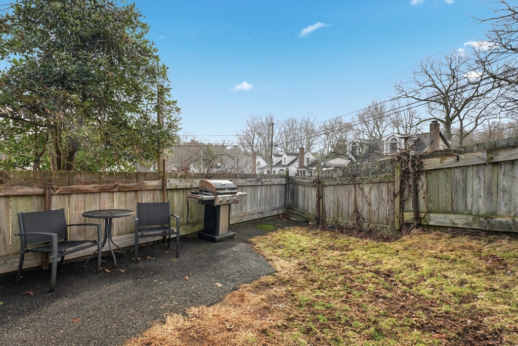 9 Pinewood Avenue Beverly, MA 01915 - Photo 36 of 41 a view of a backyard with chairs and a large tree