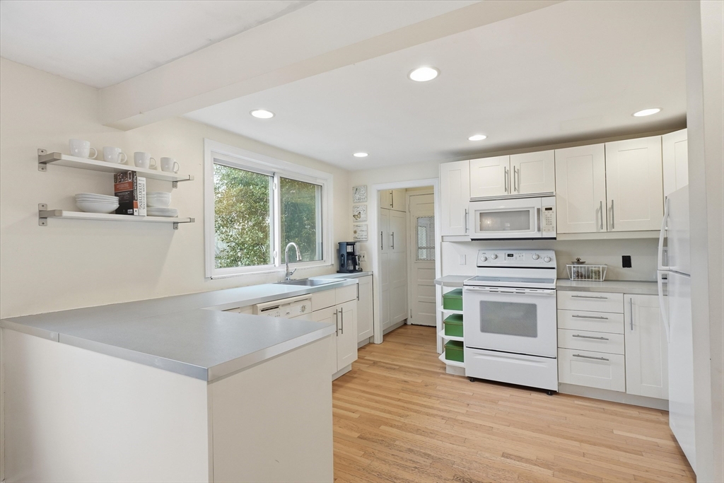 9 Pinewood Avenue Beverly, MA 01915 - Photo 9 of 41 a kitchen with a stove a sink and a refrigerator
