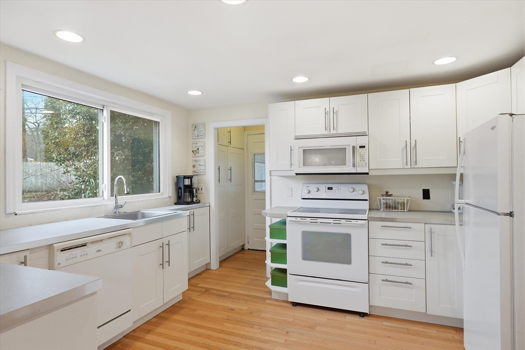 9 Pinewood Avenue Beverly, MA 01915 - Photo 10 of 41 a kitchen with white cabinets and white appliances