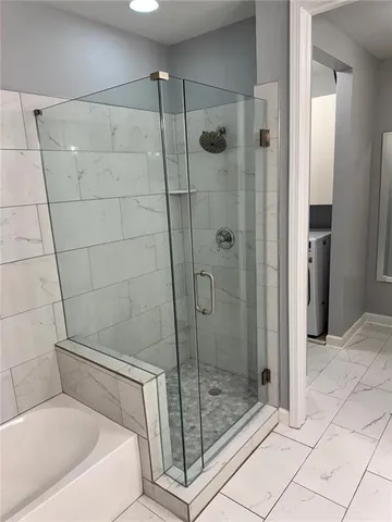 a bathroom with a bathtub and a shower