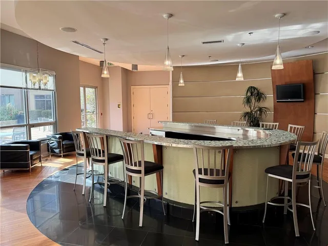 a kitchen with granite countertop a table chairs stove and sink