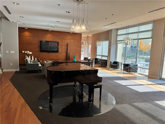 a living room with a table chairs and a flat screen tv