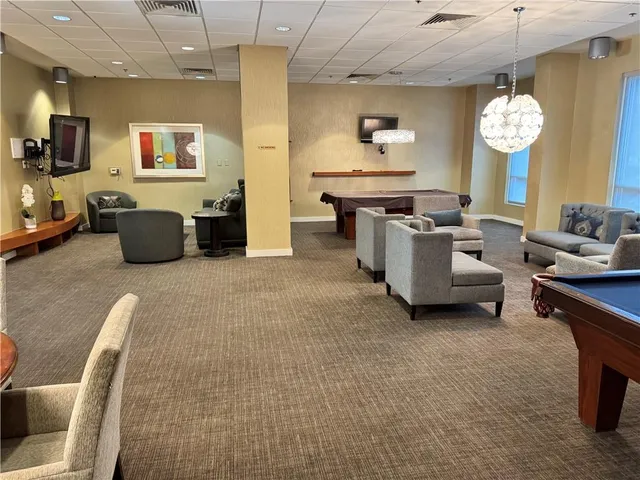 a living room with furniture kitchen view and a table