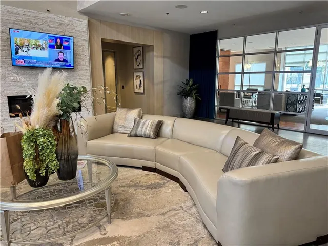 a living room with furniture and a potted plant