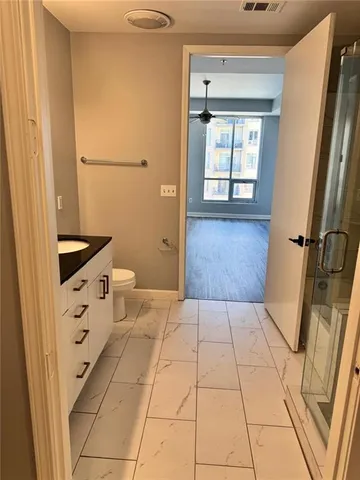 a bathroom with a sink a toilet and a shower