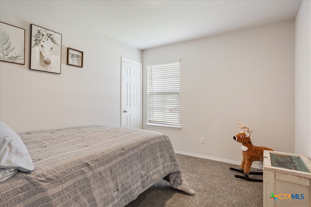 1000 Velvet Court Troy, TX 76579 - Photo 18 of 25 a bedroom with a bed and a window