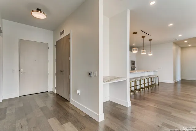 a view of kitchen with furniture and wooden floor