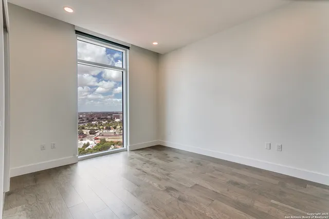 an empty room with floor to ceiling windows and closet