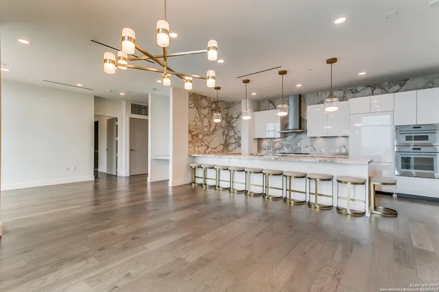 a large kitchen with a table and chairs