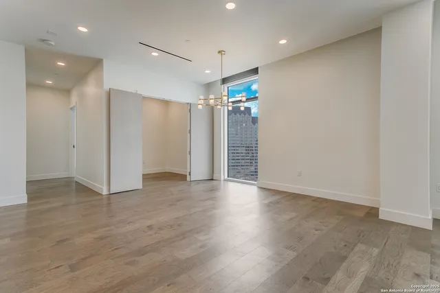 a kitchen with a table chairs refrigerator and microwave