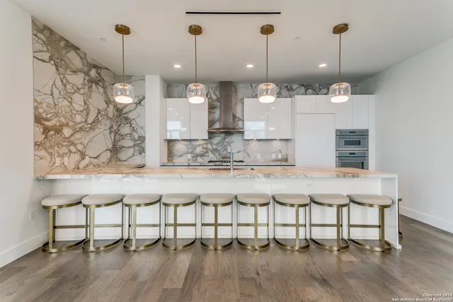 a large white kitchen with a large stove sink and refrigerator