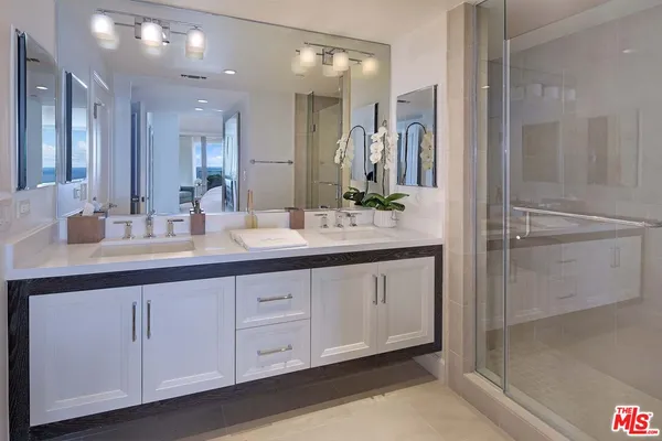 a bathroom with a double vanity sink and a mirror