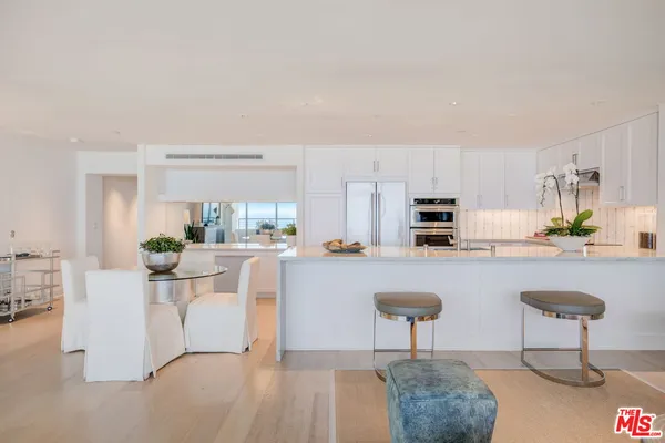 a living room with stainless steel appliances kitchen island granite countertop furniture and a view of kitchen