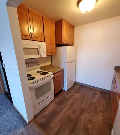 a kitchen with a stove and a refrigerator