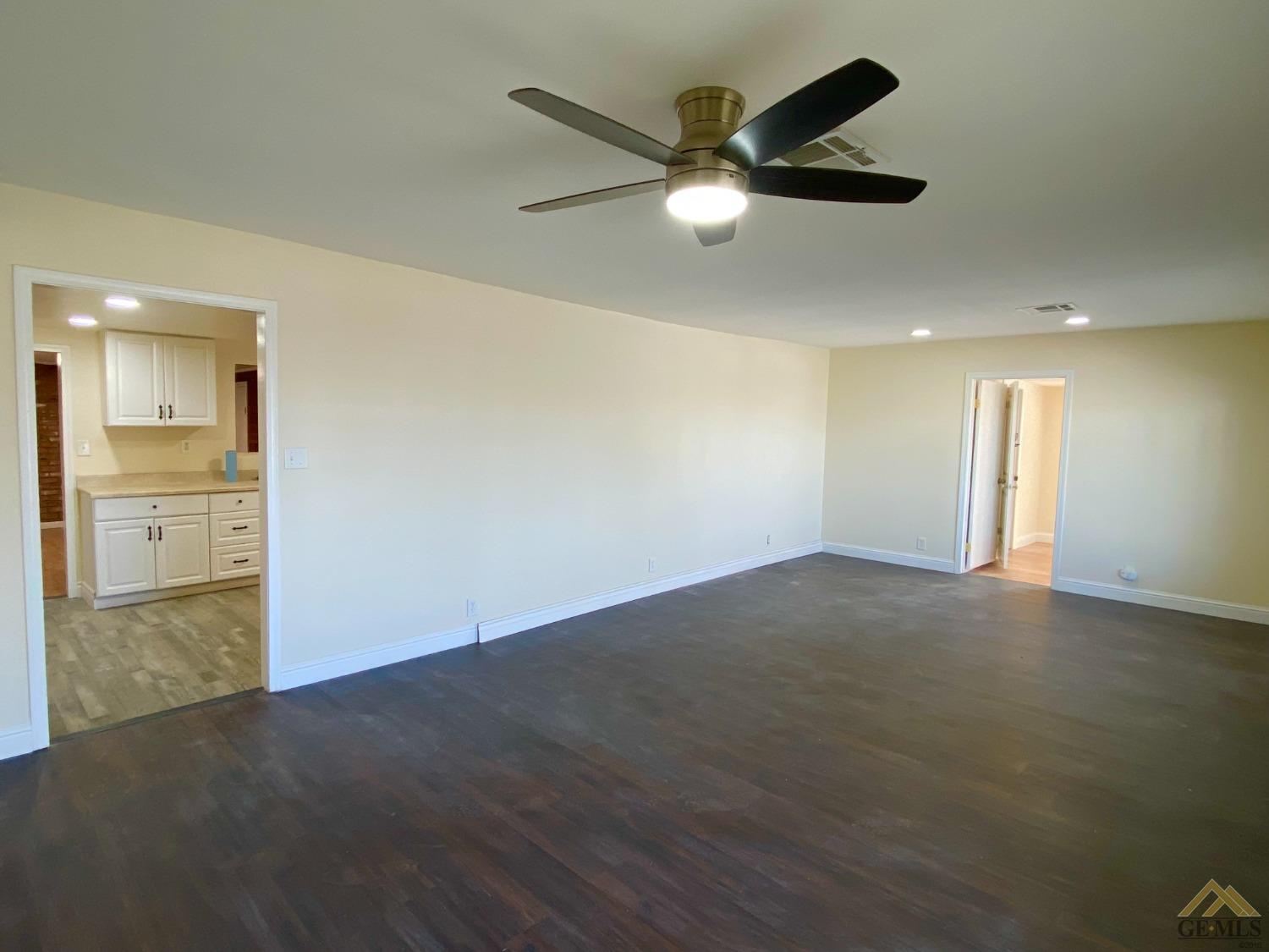 Undisclosed Address Taft, CA 93268 - Photo 13 of 22 an empty room with wooden floor and windows