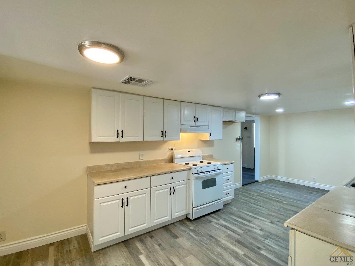 Undisclosed Address Taft, CA 93268 - Photo 10 of 22 a kitchen with a sink a stove and cabinets