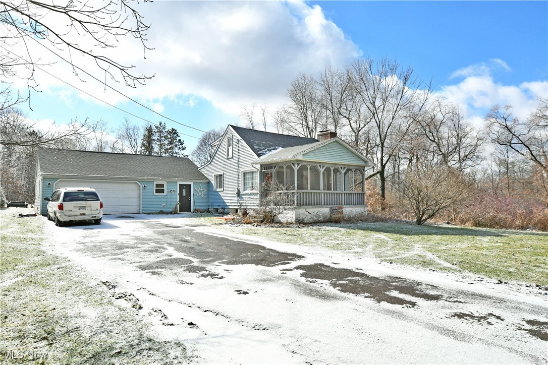 6370 Stewart Sharon Road Hubbard, OH 44425 - Photo 10 of 19 View of front of home featuring a garage, a sunroom, and a front lawn