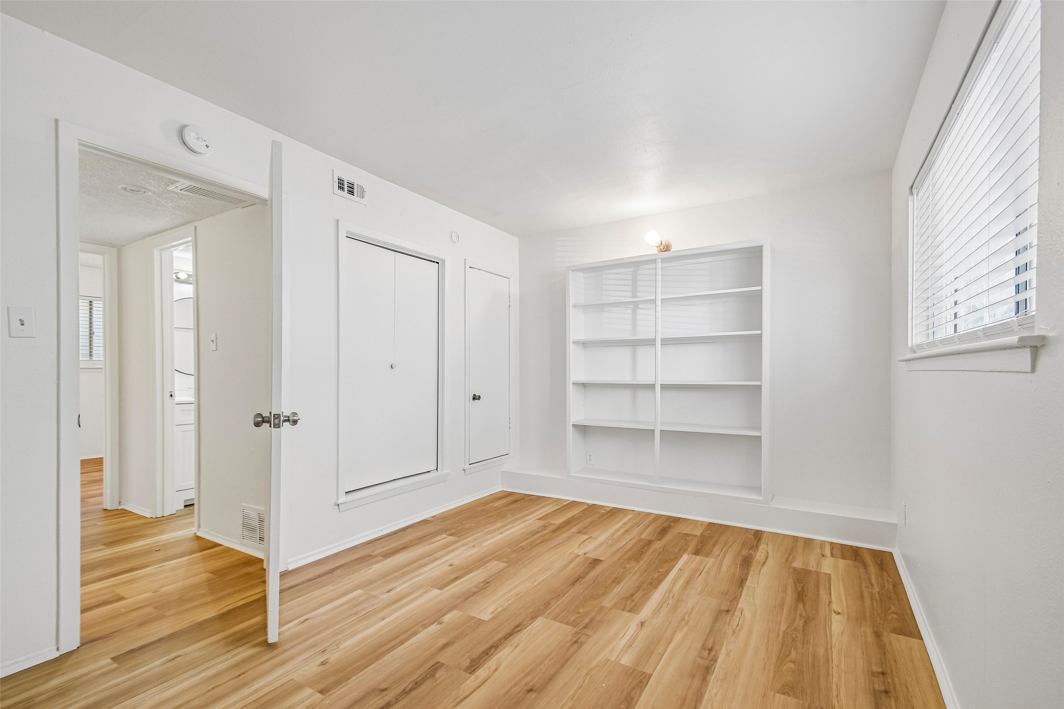 2413 Leon Street, Unit 104 Austin, TX 78705 - Photo 17 of 26 a view of a room with wooden floor and closet